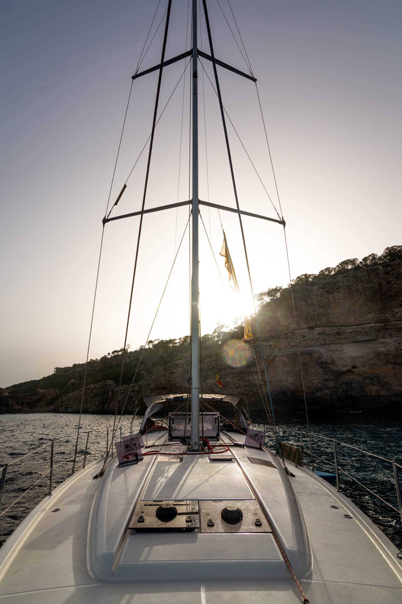 A sailwithus yacht sailing off the coast of Mallorca in clear blue water