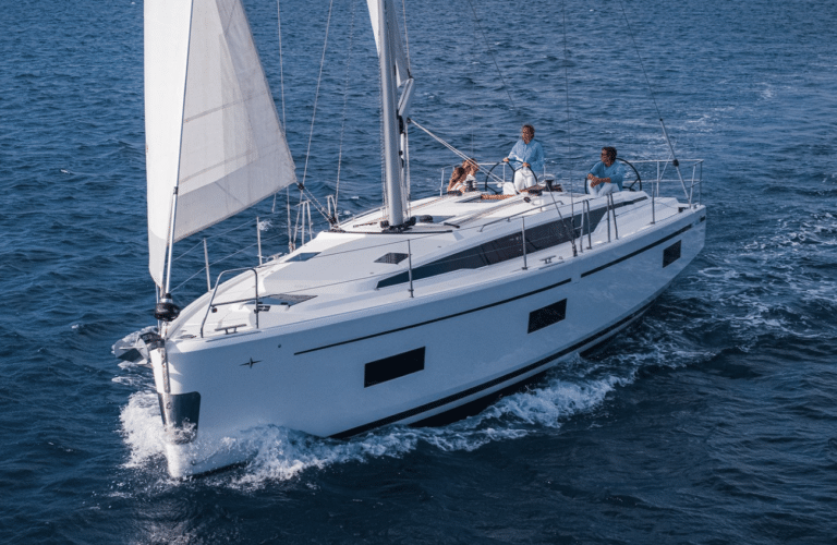 A white Bavaria C42 sailing yacht under full sail in a steady breeze