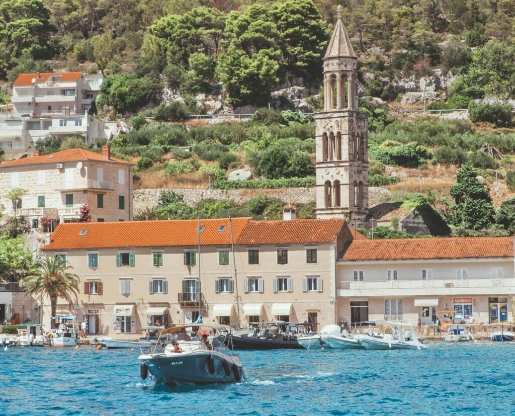 A picturesque view of Hvar harbor showcasing historic architecture and a serene waterfront.