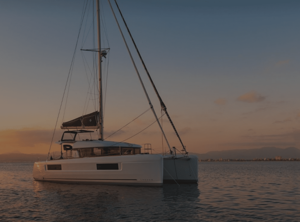 Sailors relaxing on a catamaran at sunset during a shared trip